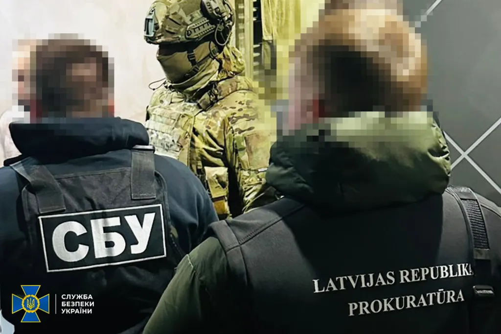 Police footage showing the arrest of fraud ring organizers who defrauded EU citizens of <img src=